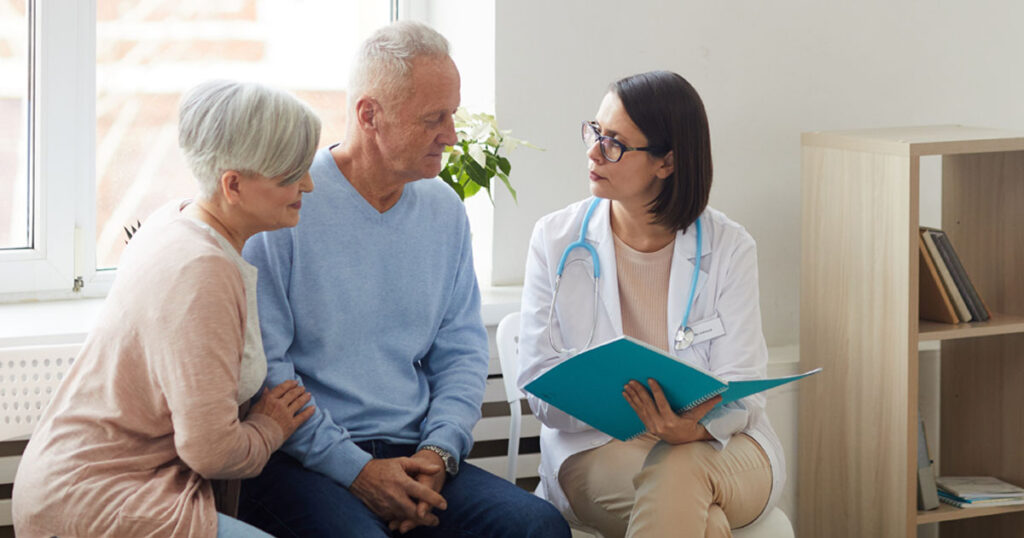 An Older Couple with a Doctor in a Waiting Room