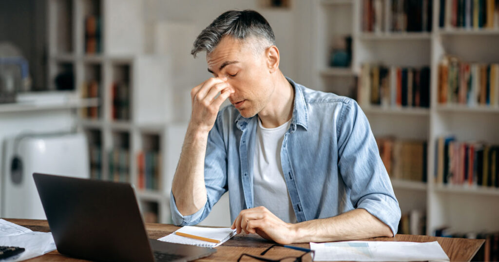 A Frustrated Man in His Home Office