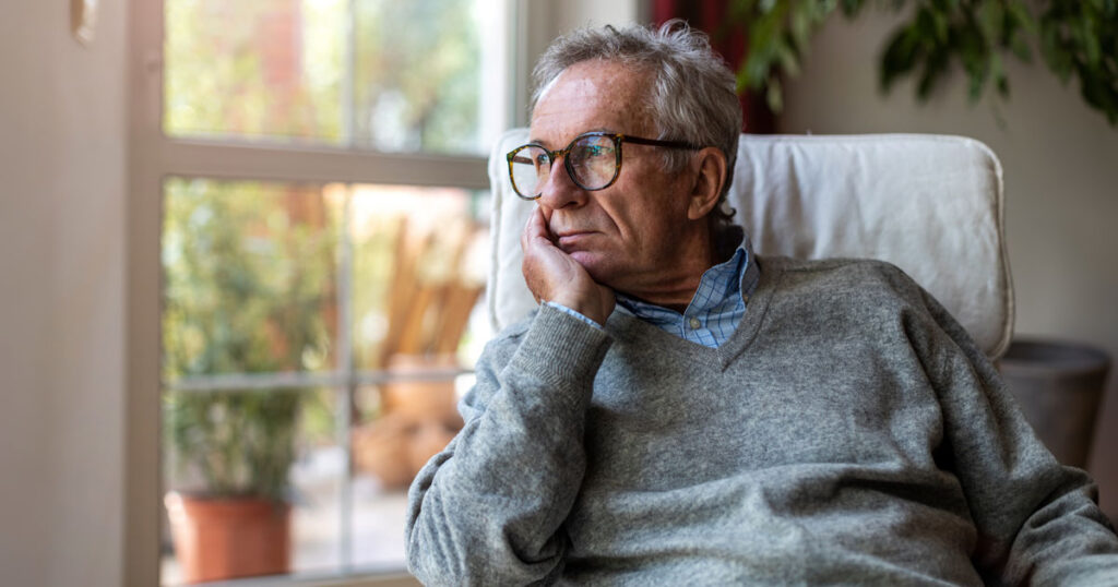 A Nervous Looking Man Looking Out the Window