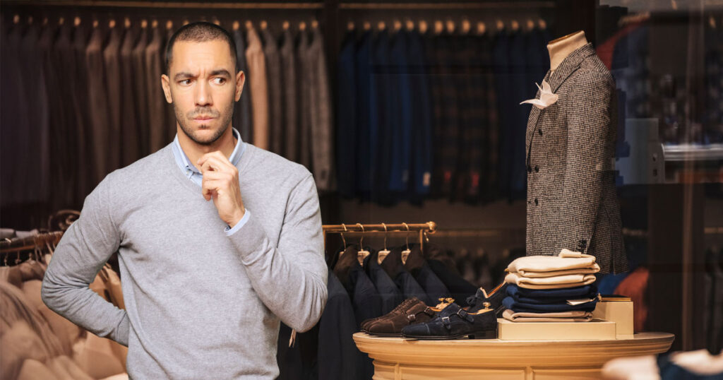 Man experiencing lifestyle creep as he contemplates discretionary purchases.