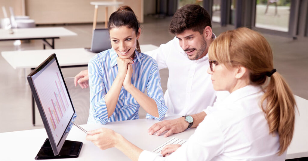 A young couple looking at their early retirement plan with an advisor